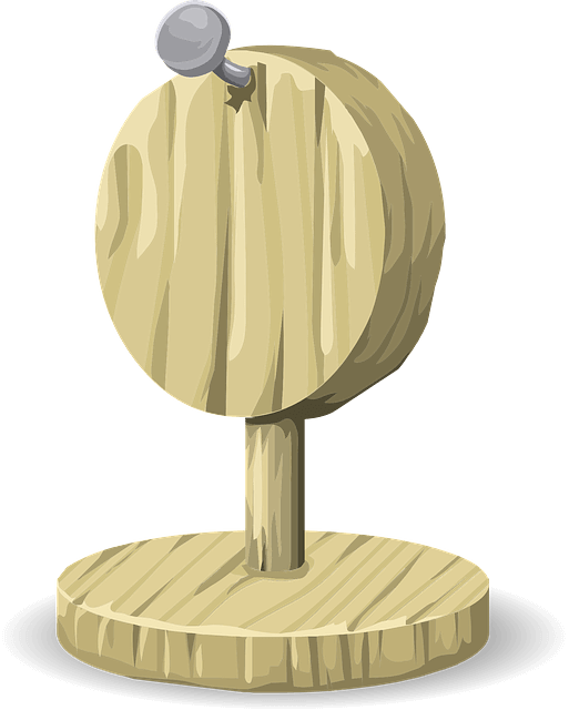 A small woodworking piece with a nail near the top
